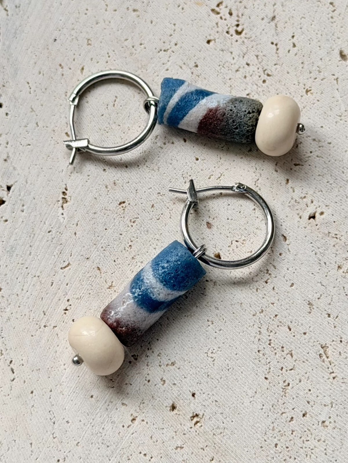 Silver-tone hoop earrings with hand-finished striped glass beads by E-SHOO