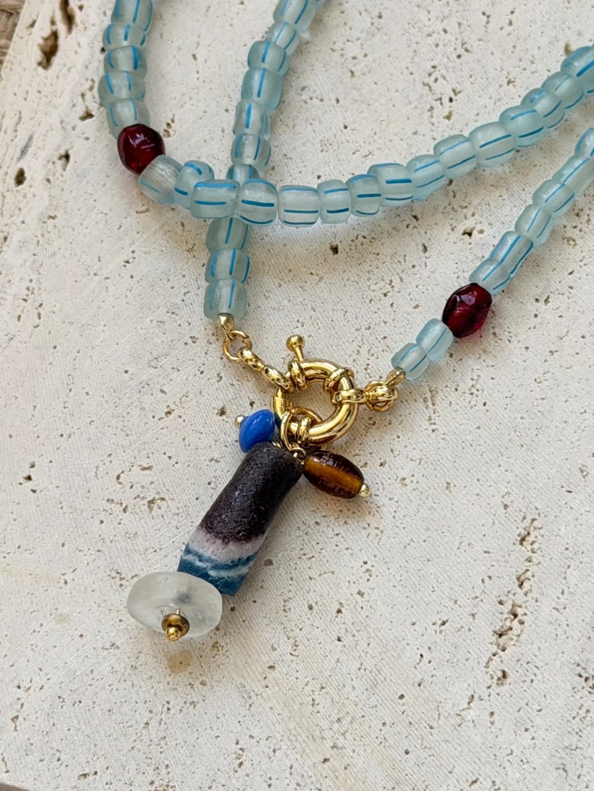 Long sky blue glass bead necklace with striped charm by E-SHOO