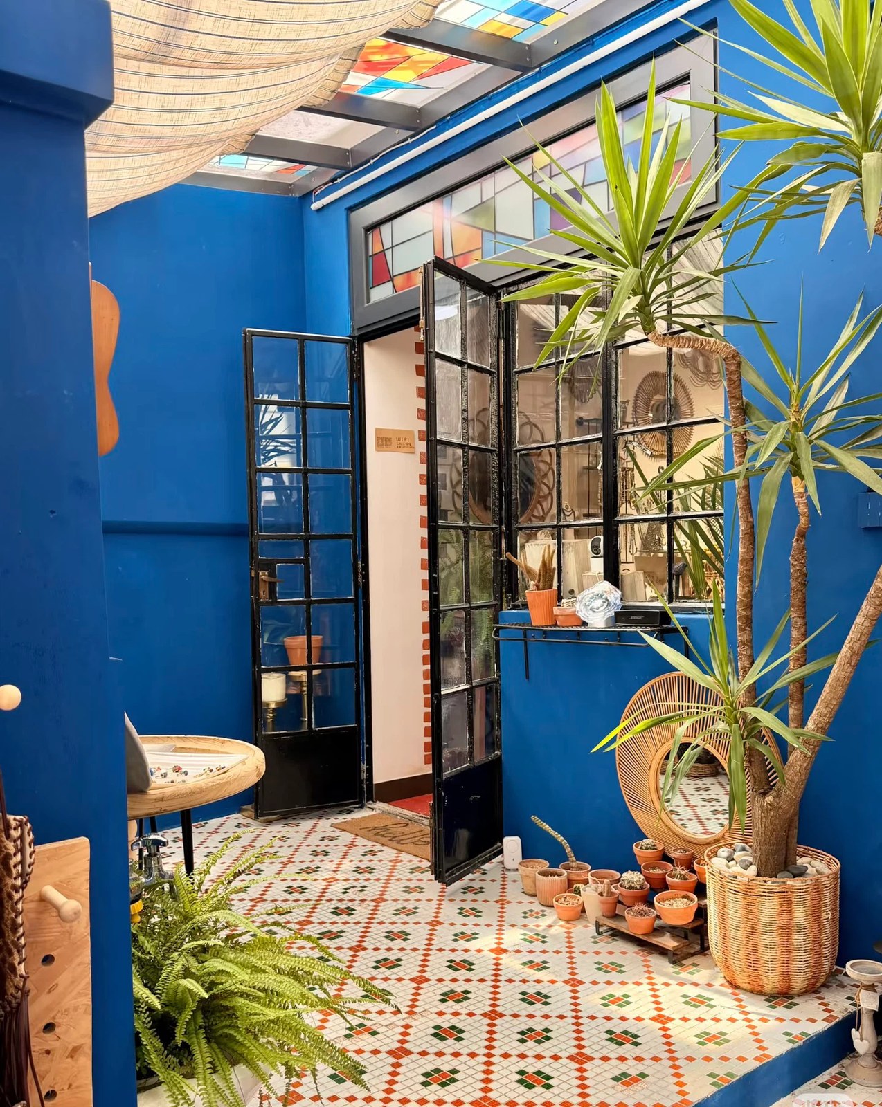 The plant-filled tiled entrance of the Shanghai studio
